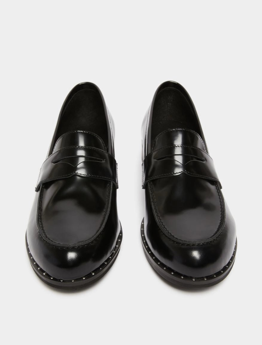 black leather loafers with small heel and metallic dot detailing along the edging form iblues front view