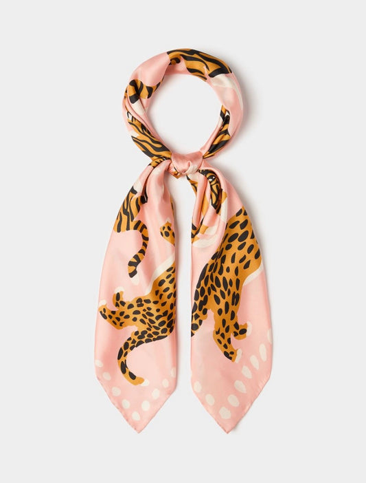 A pink silk scarf featuring a leopard print pattern with black and orange spots, tied in a loop at the top and displayed against a light gray background.