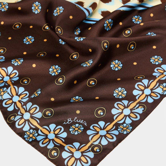 Brown fabric with blue floral patterns on a white background