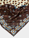 Brown fabric with blue floral patterns on a white background
