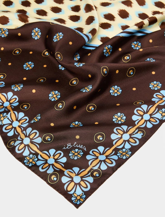 Brown fabric with blue floral patterns on a white background