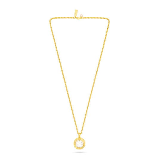 A delicate yellow gold chain necklace with a small circular pendant featuring a clear round gemstone, displayed against a solid white background.
