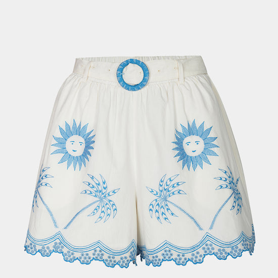 White shorts with blue sun and palm tree patterns on a white background