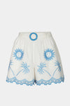 White shorts with blue sun and palm tree patterns on a white background