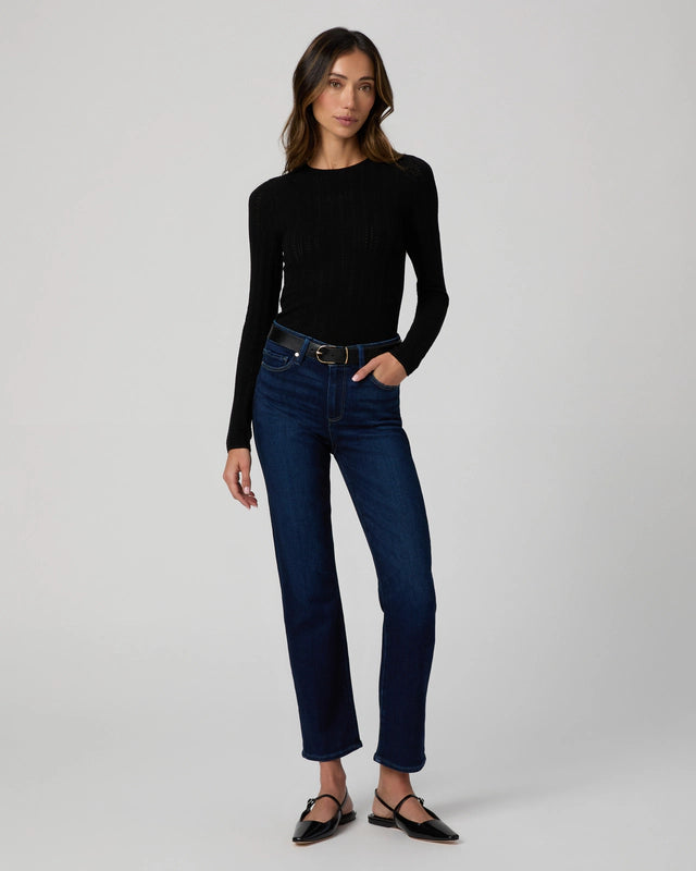 Dark wash stretch skinny jeans on model wearing long sleeve tee