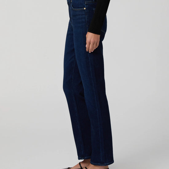 Person wearing dark blue jeans from Paige