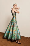 Woman wearing a colorful patterned dress against a neutral background