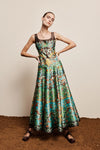 Woman wearing a colorful patterned dress on a plain background