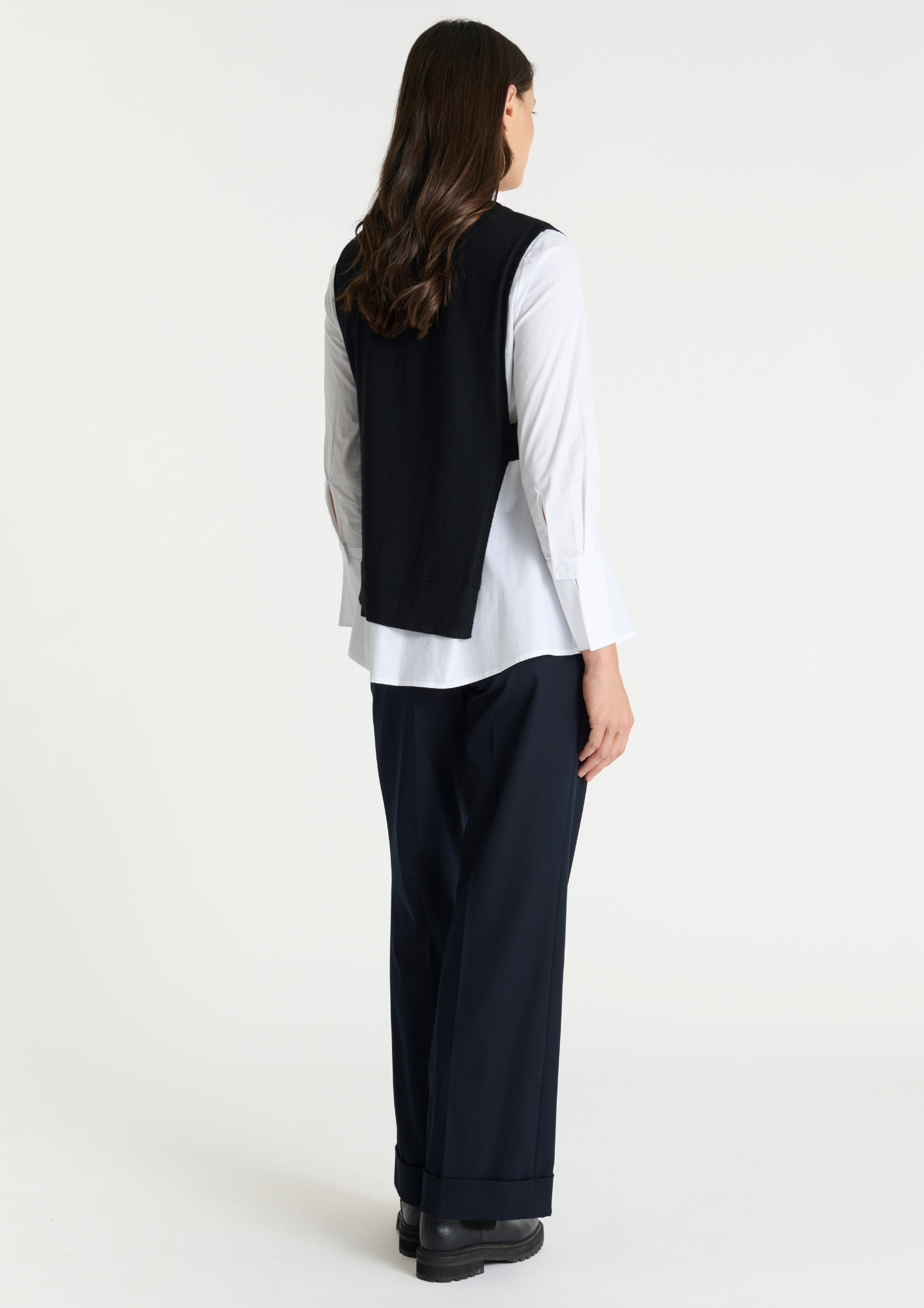 Black pullover vest with ribbed neck knit. Rear view.