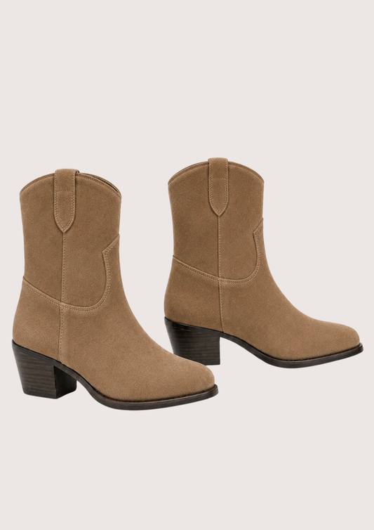 A pair of women's mid-calf western-style boots in tan suede, featuring a stacked block heel and dark sole, shown against a light beige background.