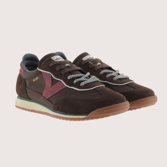 A dark brown suede and mesh sneaker with burgundy accents, featuring a cream midsole and a gum outsole, shown from a side profile on a light gray background.