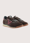 A dark brown suede and mesh sneaker with burgundy accents, featuring a cream midsole and a gum outsole, shown from a side profile on a light gray background.