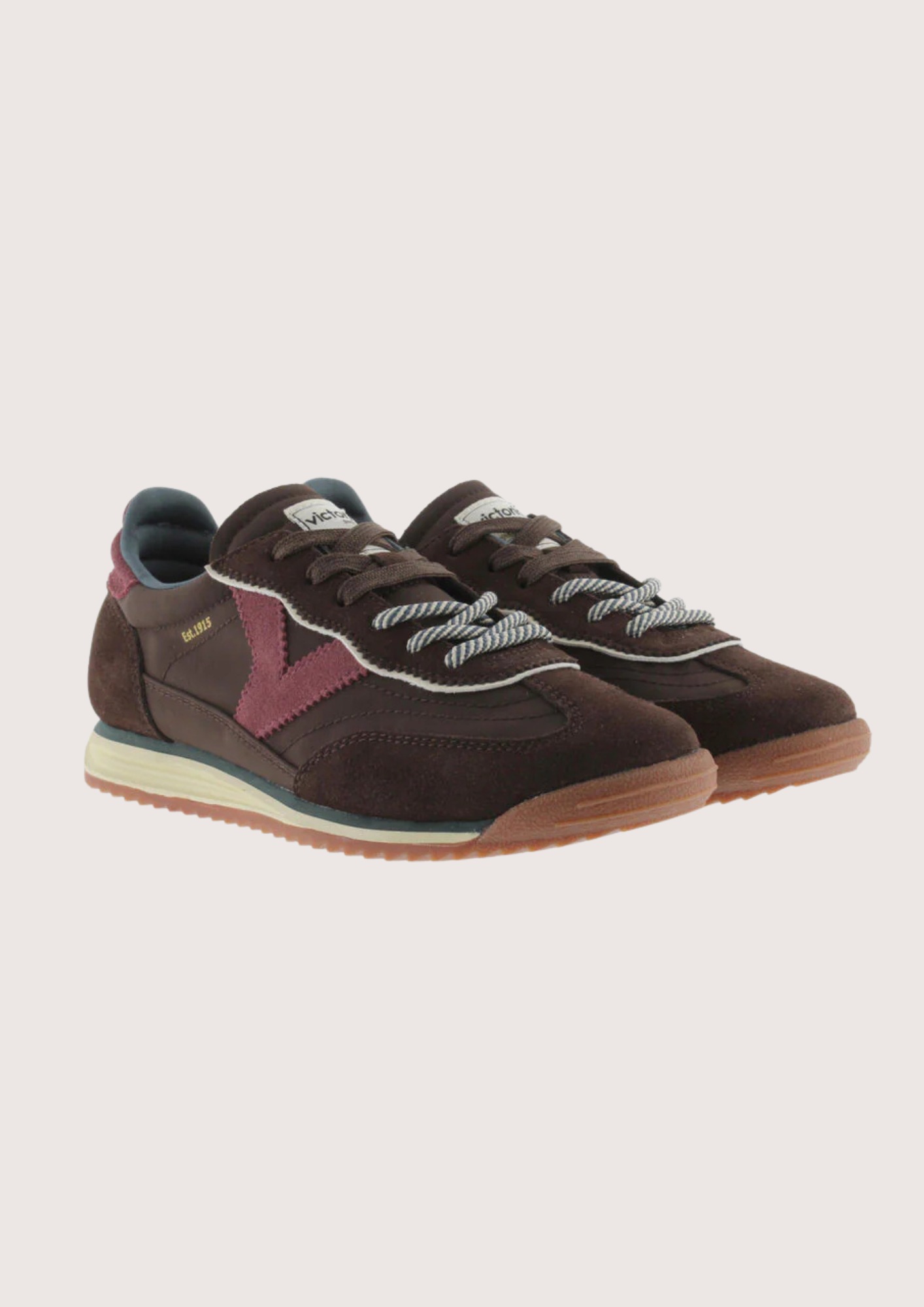 A dark brown suede and mesh sneaker with burgundy accents, featuring a cream midsole and a gum outsole, shown from a side profile on a light gray background.