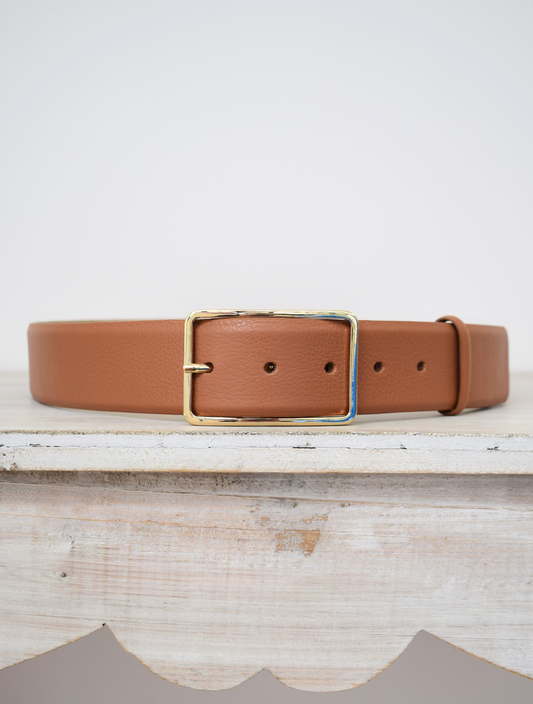 Wide tan belt with thin gold buckle 