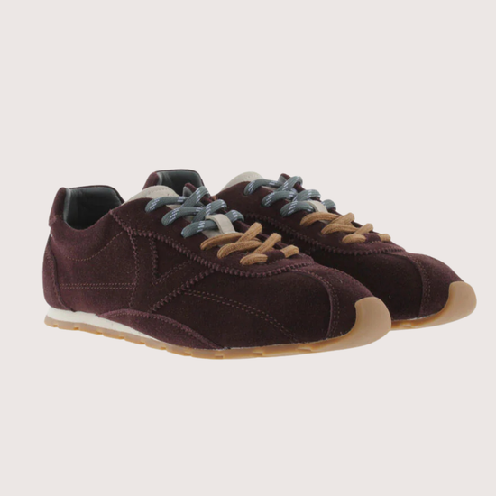 Brown suede sneaker with beige sole on a white background