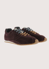 Brown suede sneaker with beige sole on a white background
