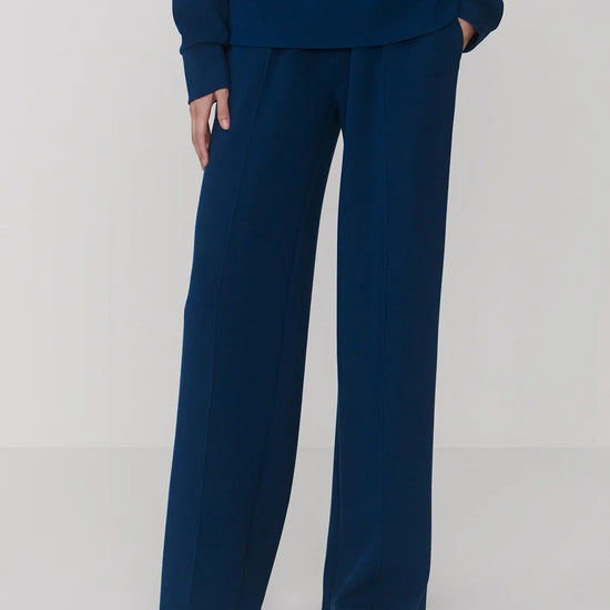 Navy blue outfit with a top and wide-leg pants on a white background