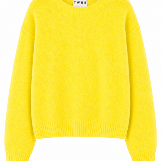 A bright yellow long-sleeve knit sweater with a crew neck, shown flat against a plain white background. A small white brand label reading 'TWN5' is visible inside the collar.