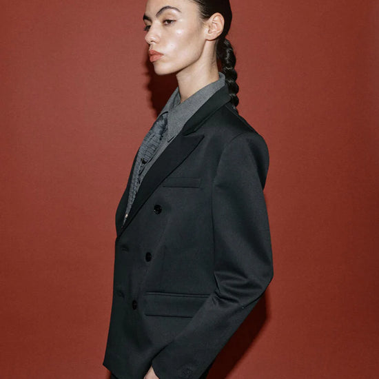 double breasted black blazer with notch lapels and welted flap pockets from heyanno side view