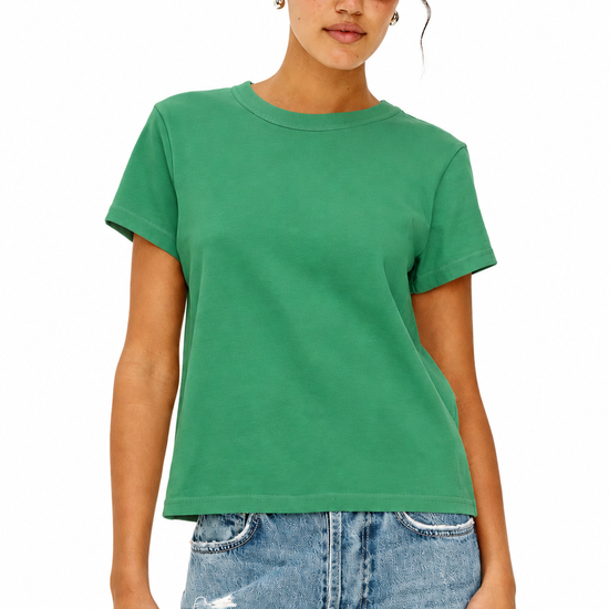 model wearing green tee and blue jeans
