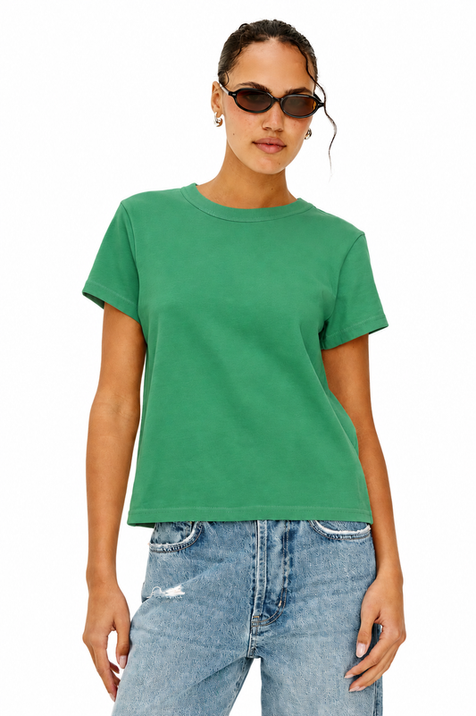 model wearing green tee and blue jeans