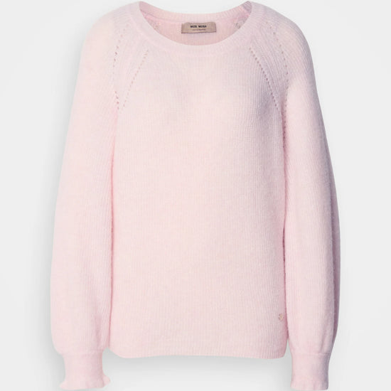 Pink sweater on a light gray background
