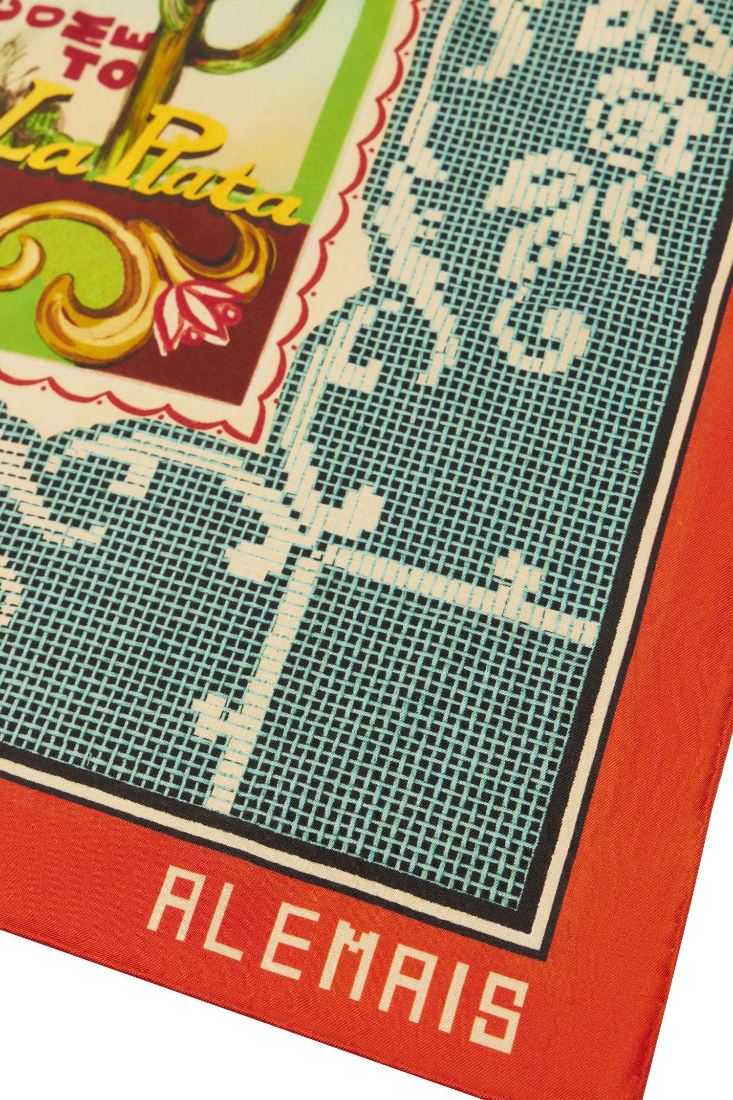 A close-up of a square scarf or bandana featuring a vintage-style print. The design includes a teal grid pattern with white floral scrollwork, a red border, and a decorative multicolor label area with the text 'DEO TO La Plata' and 'ALEMAIS' in white on the red border.