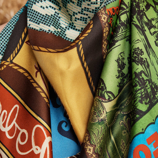 Close-up of a colorful patterned scarf with visible brand name.