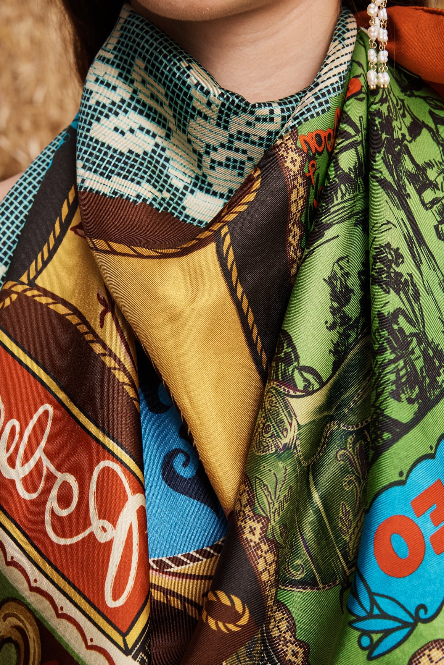 Close-up of a colorful patterned scarf with visible brand name.