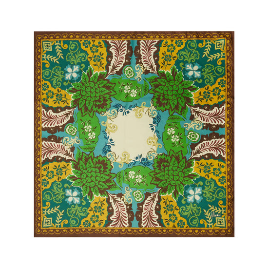 A square scarf with an intricate botanical and floral pattern, featuring shades of green, yellow, brown, and blue, with a central cream-colored square.