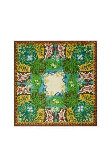 A square scarf with an intricate botanical and floral pattern, featuring shades of green, yellow, brown, and blue, with a central cream-colored square.