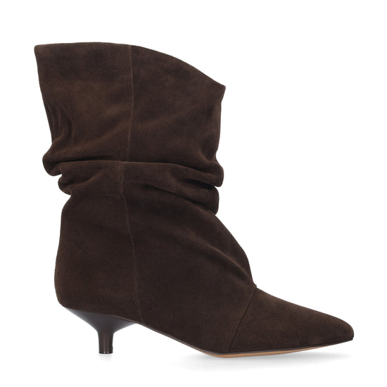 A dark brown suede slouch ankle boot with a pointed toe and a short kitten heel, shown from a side profile on a white background.