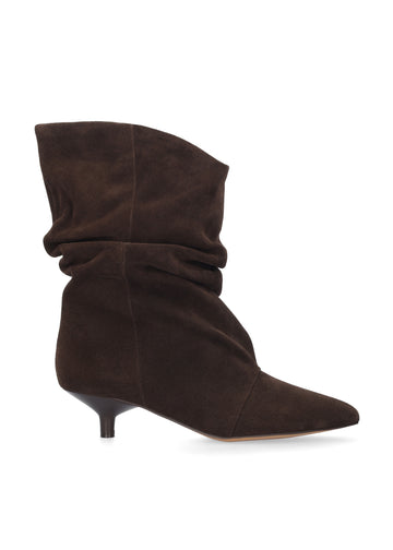 A dark brown suede slouch ankle boot with a pointed toe and a short kitten heel, shown from a side profile on a white background.
