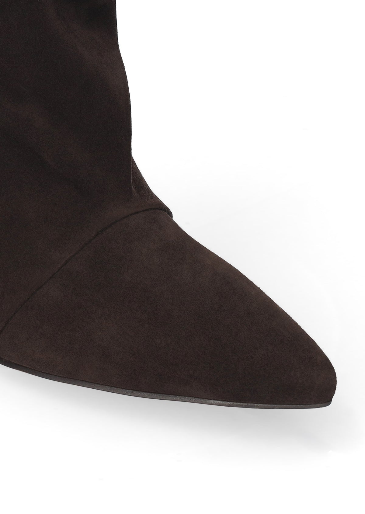 Close-up of a dark brown suede boot with a pointed toe on a white background.