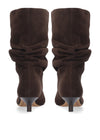 A pair of dark brown suede slouchy mid-calf boots with pointed toes and slim dark heels, shown from the back on a white background.