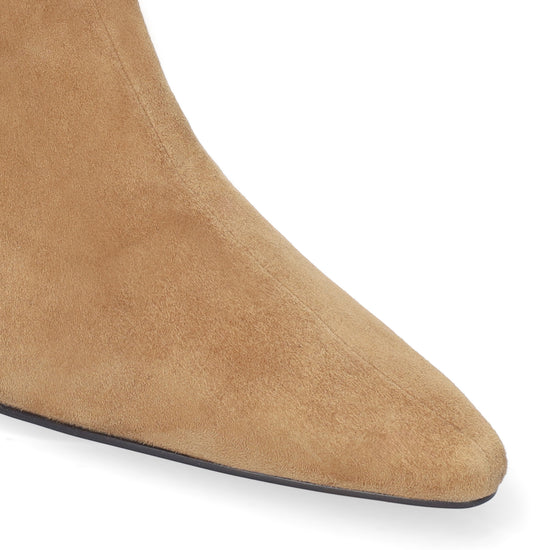 Close-up of a tan suede ankle boot with a pointed toe on a white background.
