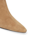 Close-up of a tan suede ankle boot with a pointed toe on a white background.