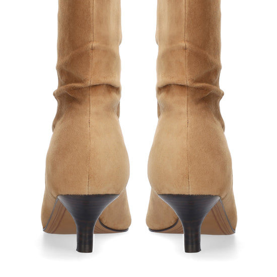 A pair of tan suede mid-calf boots with black kitten heels, shown from the back on a white background.