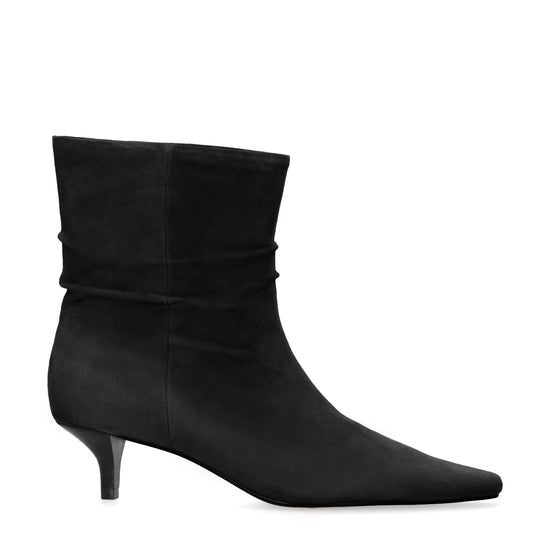 A single black suede ankle boot with a pointed toe and a short kitten heel, shown from a side profile on a plain white background.