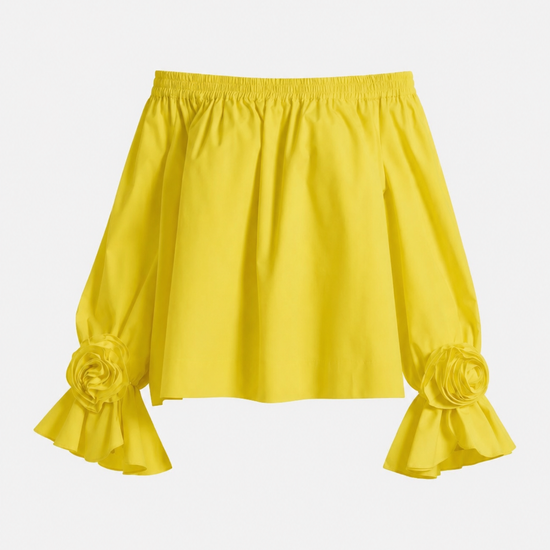 Yellow blouse with ruffled sleeves on a light gray background