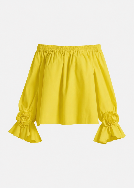 Yellow blouse with ruffled sleeves on a light gray background