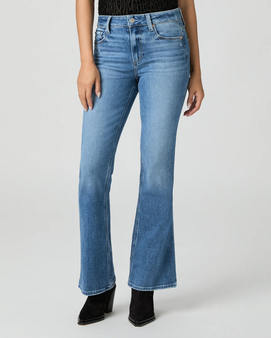 Blue jeans by Paige worn by a person on a white background
