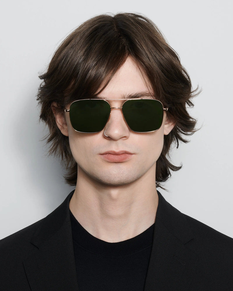 Gold coloured steel frame sunglasses with a square lense model shot