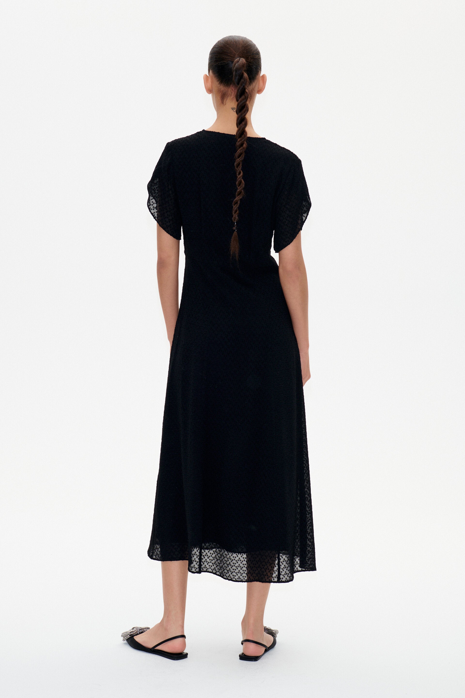 Black V neck midi dress with short tulip sleeves and a textured fabric