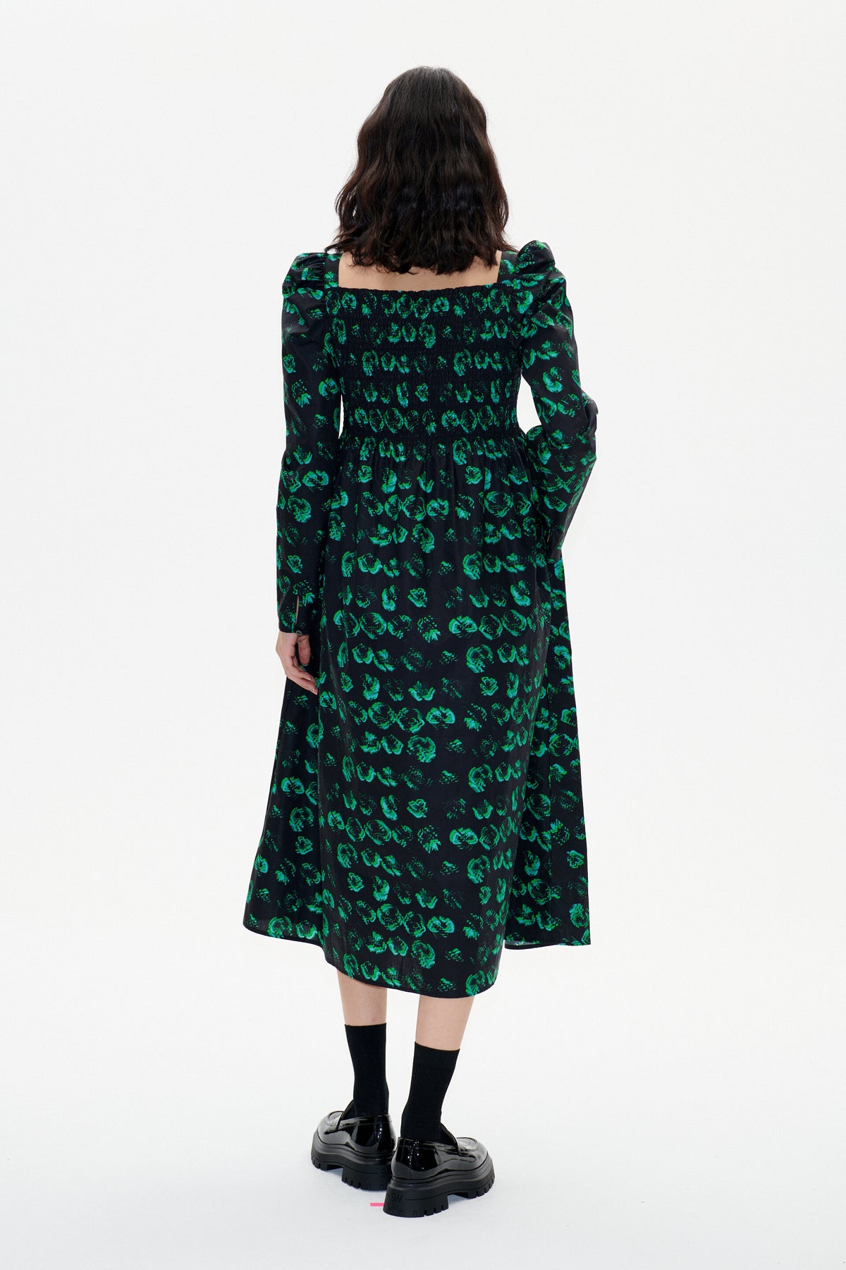 Black and green midi dress with full skirt long sleeves and ruched bodice with distorted pansy print