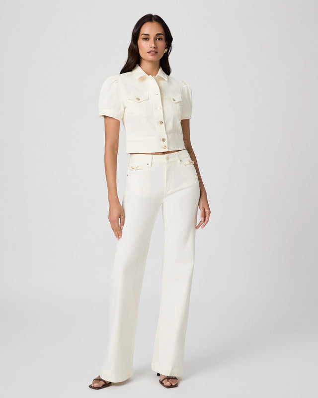 Woman wearing a white outfit on a plain background