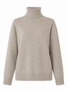 A light beige turtleneck sweater with long sleeves and ribbed cuffs and hem, shown on a plain white background.