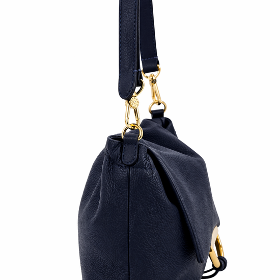 navy leather bag with gold accents on a white background