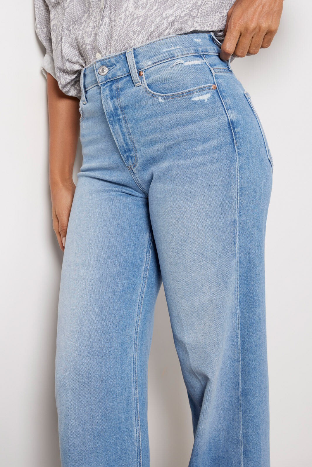 Pale wash raw hem jeans with a wide straight leg