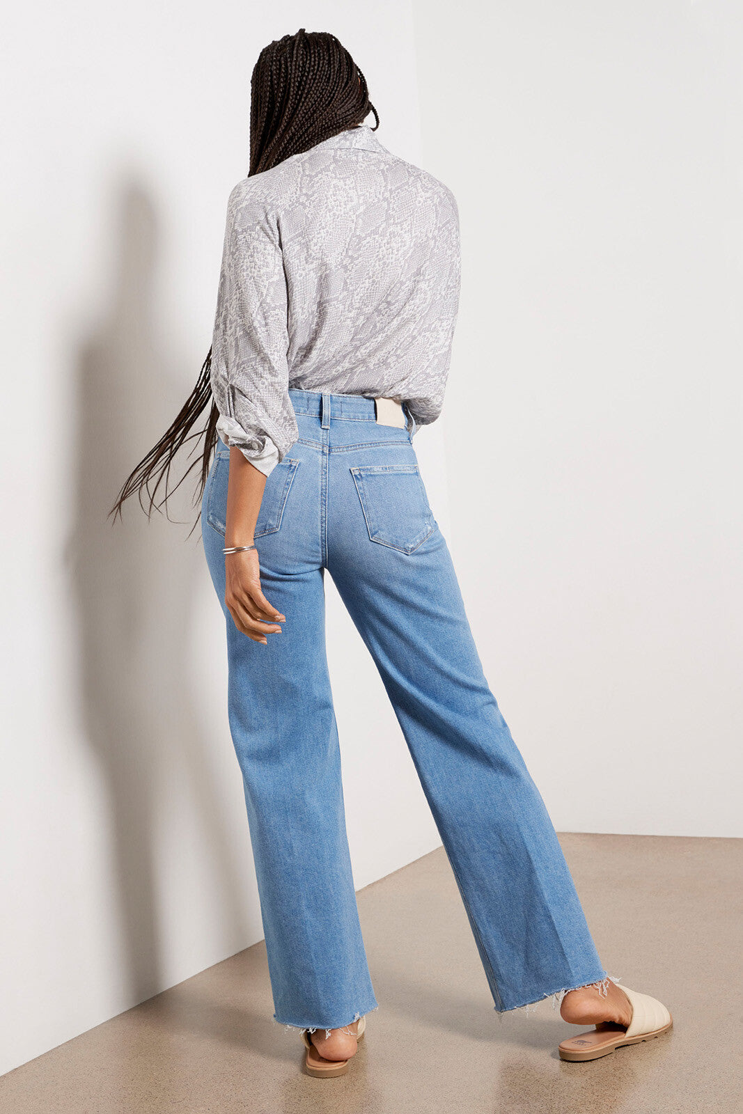 Pale wash raw hem jeans with a wide straight leg